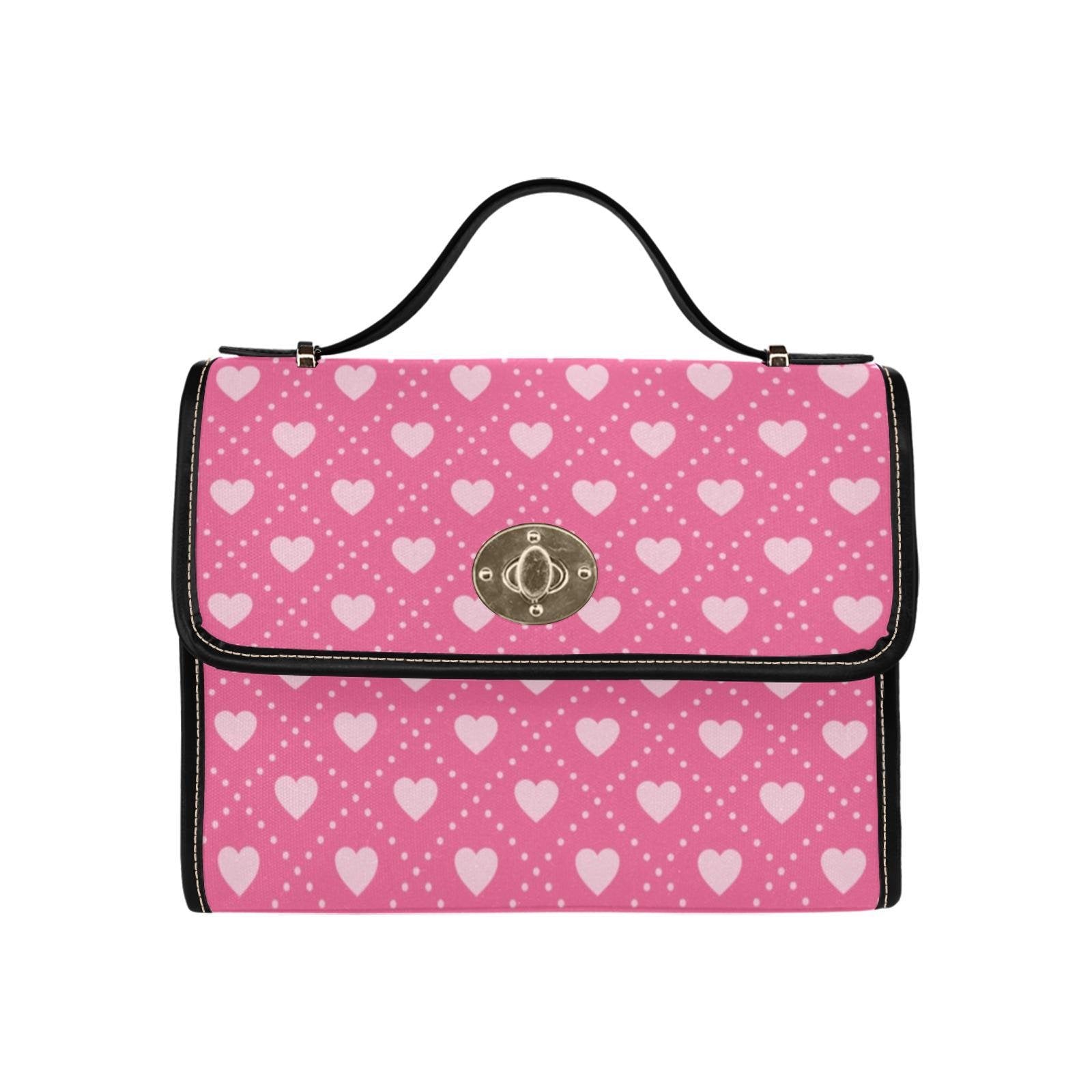 a pink and white purse with hearts on it