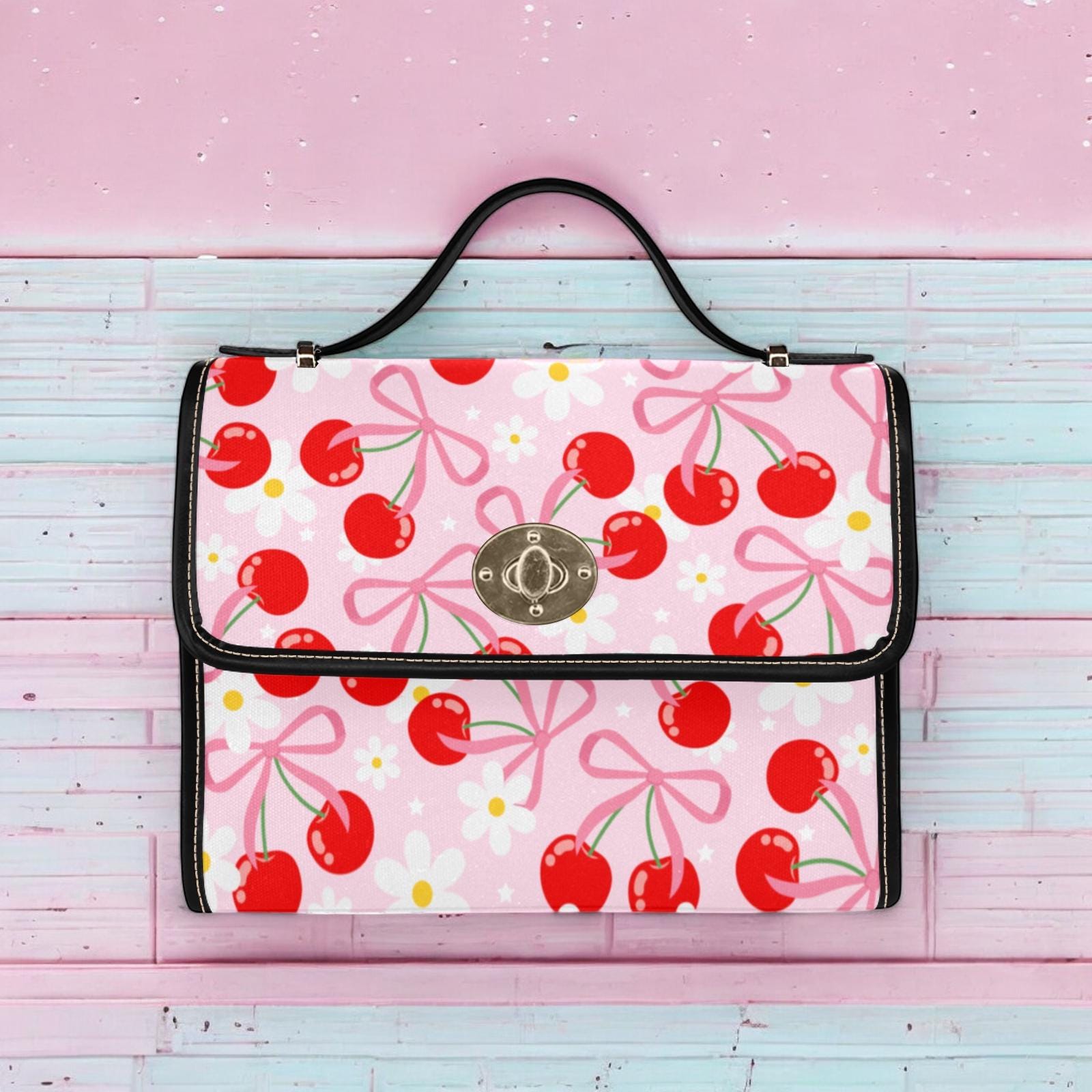 a pink bag with cherries on it